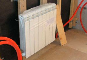 When attaching the radiator to a wooden wall, you must take into account the possibility of its shrinkage